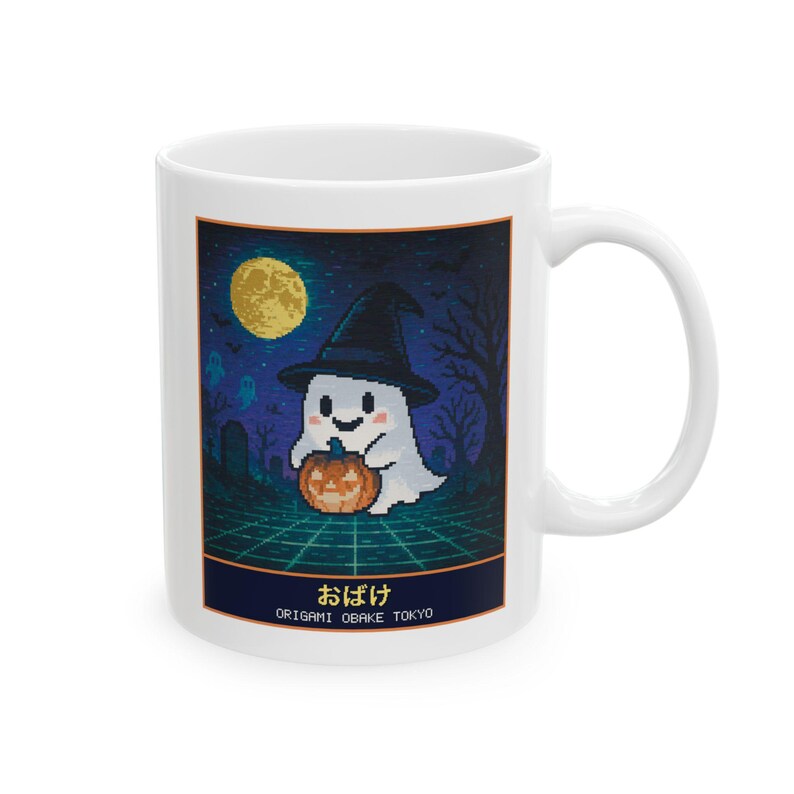 White ceramic mug with a pixel-art ghost in a witch hat