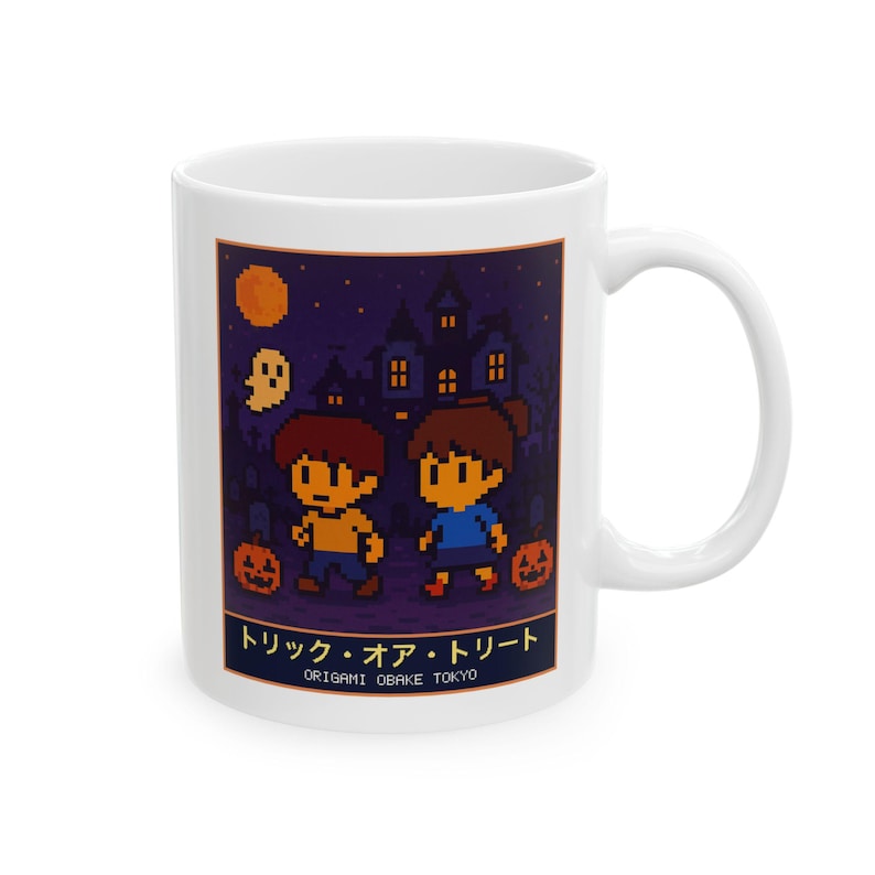 White ceramic mug with a pixel-art haunted house trick-or-treat scene